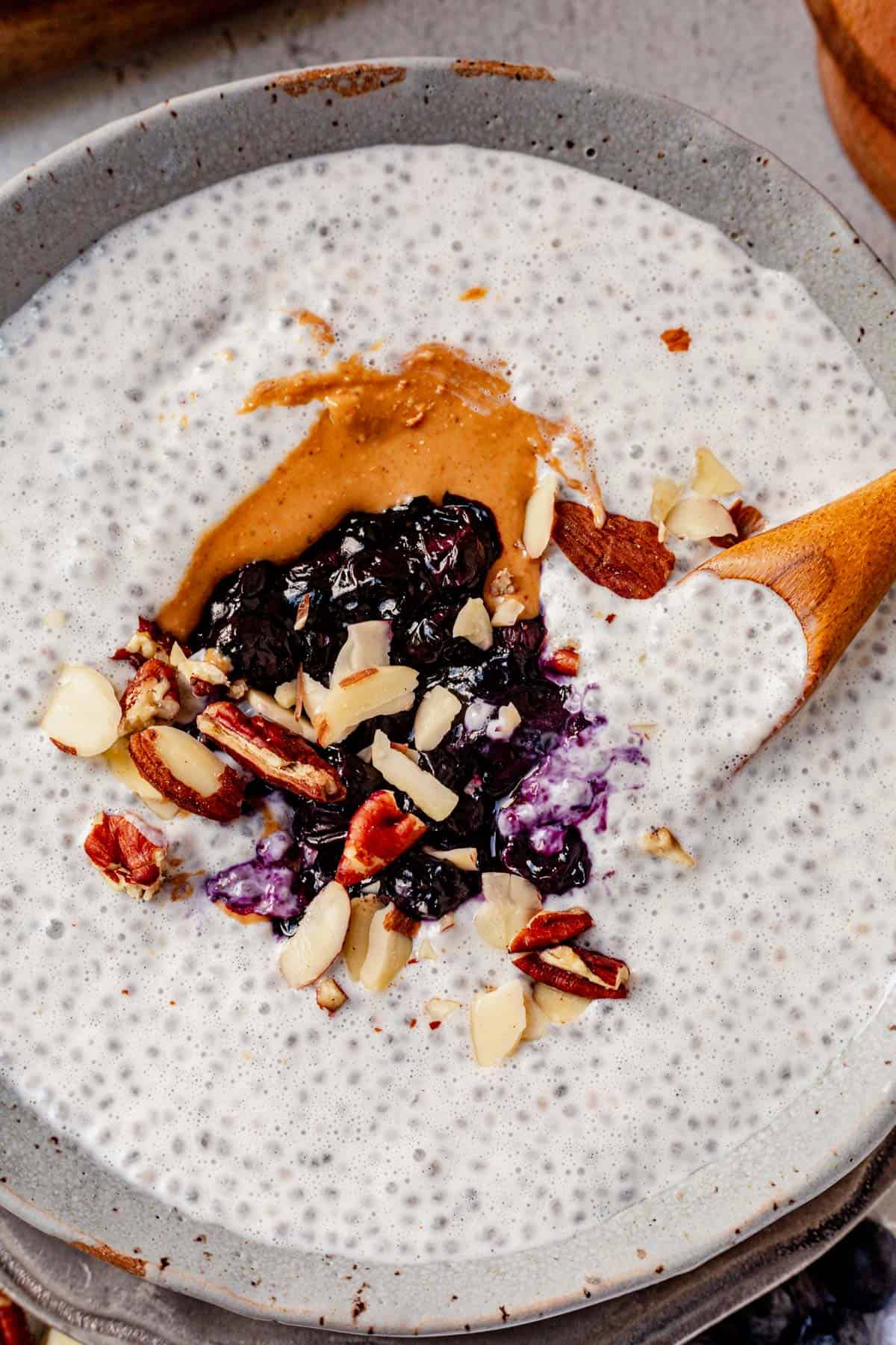 chia yogurt pudding in a bowl with nut butter and berries