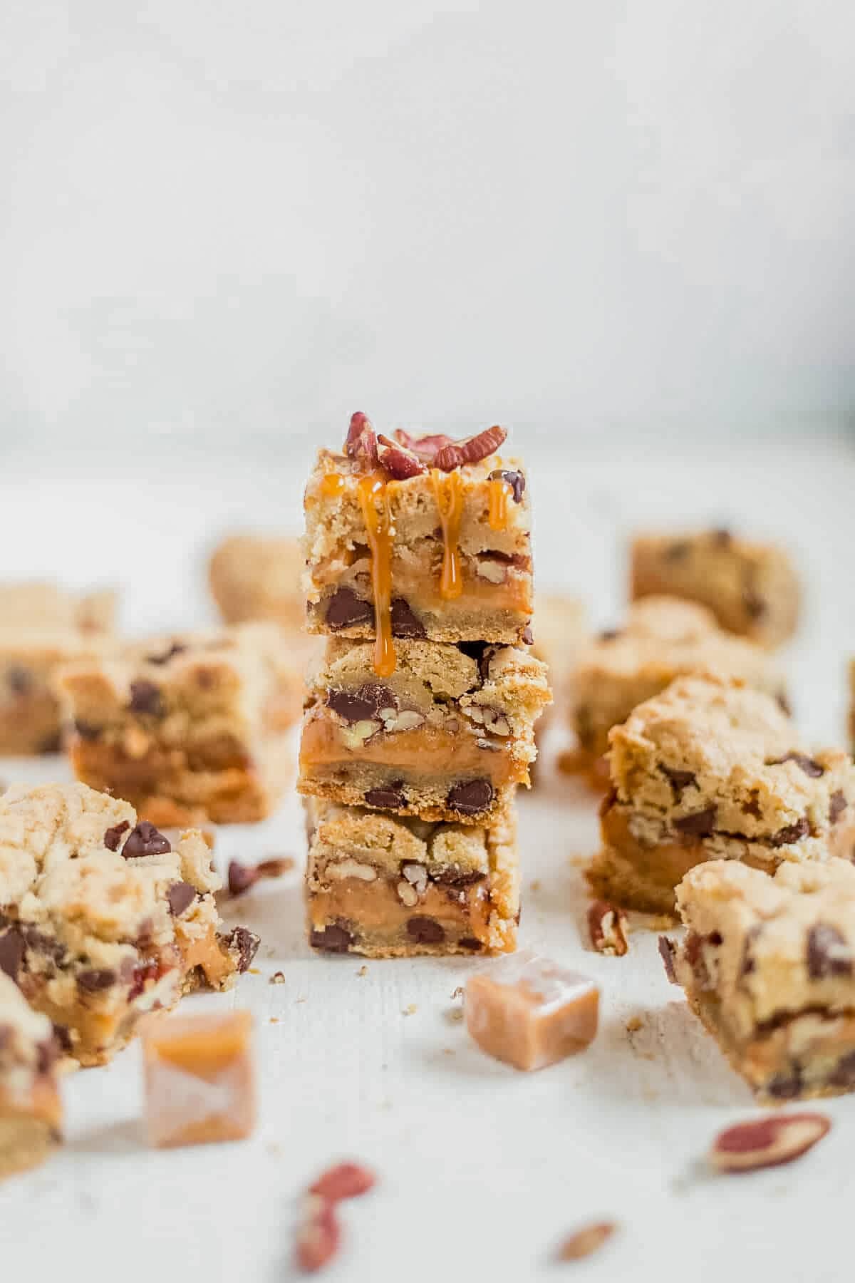 three cookie turtle bars with caramel on top