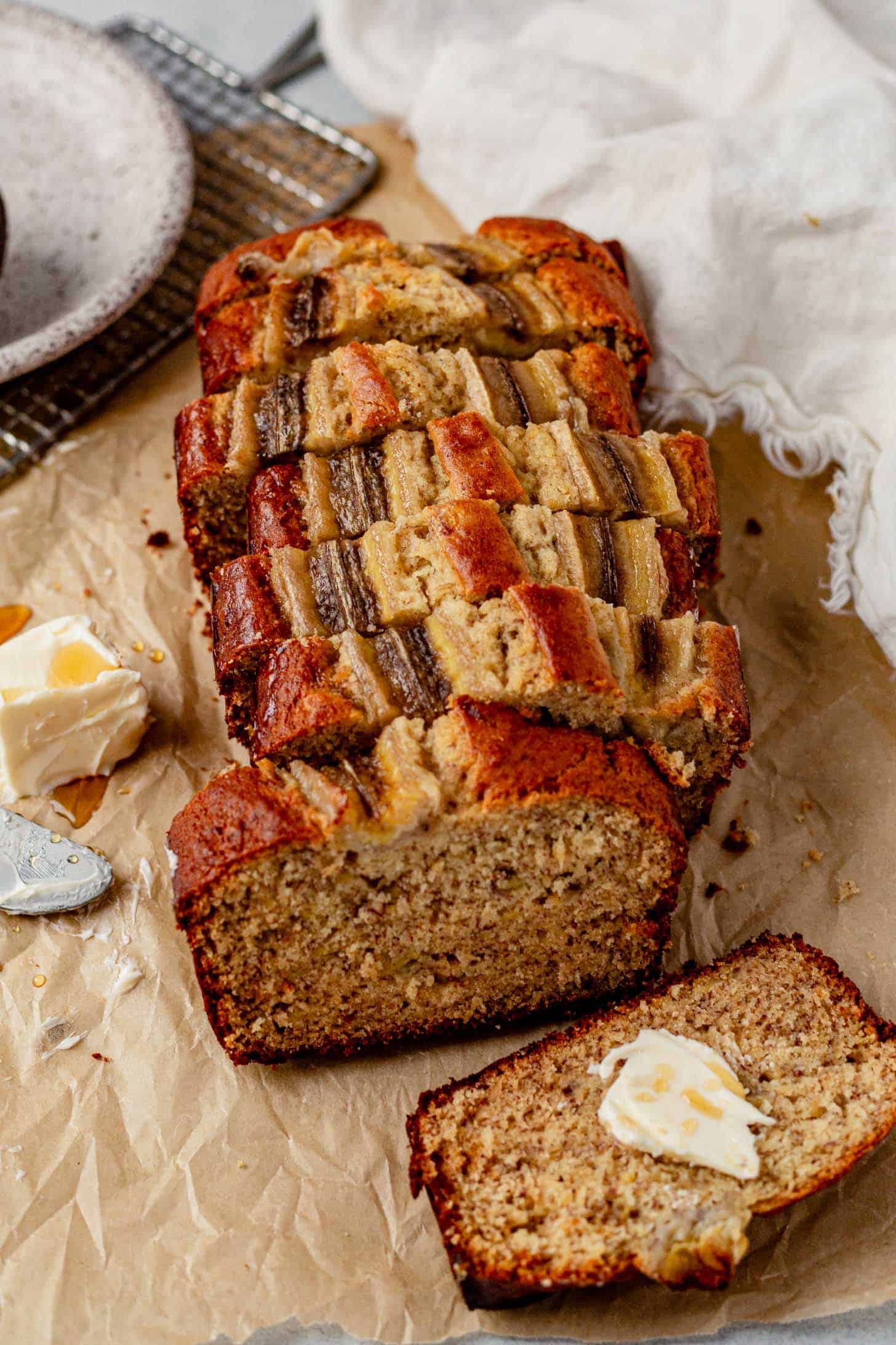 a loaf of brown butter banana bread sliced into pieces