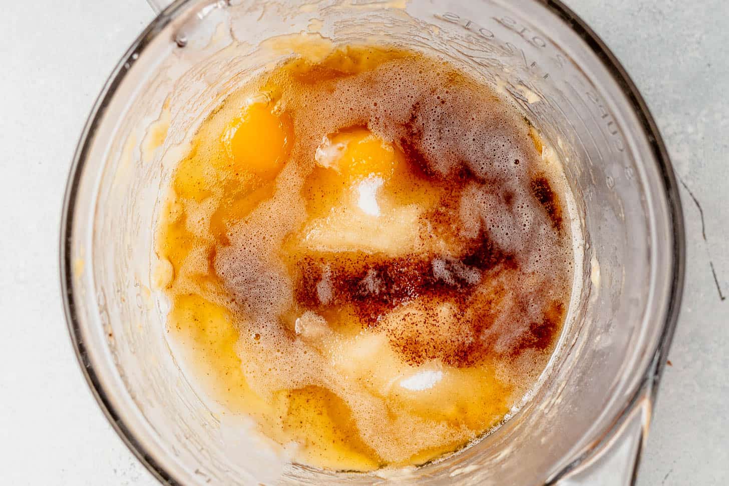 wet ingredients in a mixing bowl for brown butter banana bread