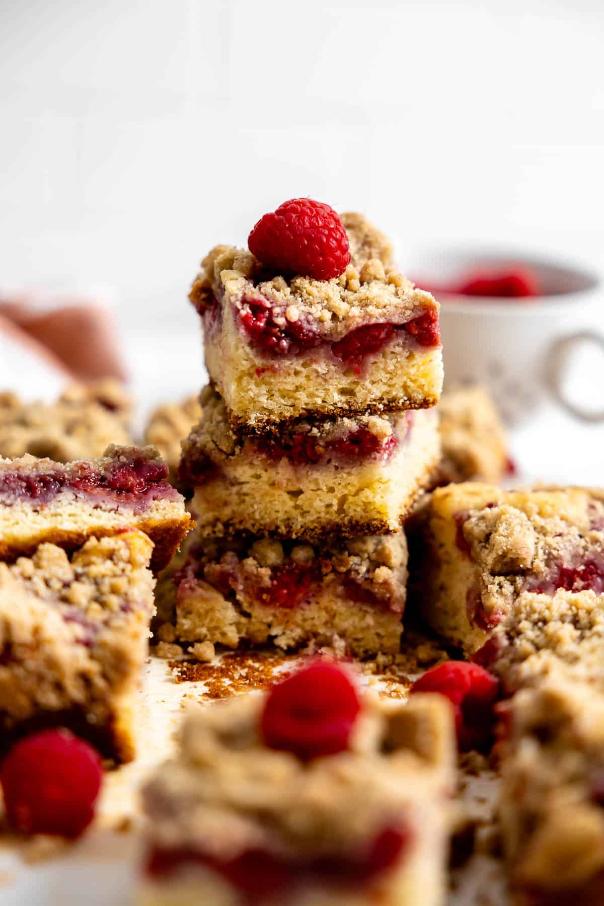 3 pieces of raspberry coffee cake stacked on a counter