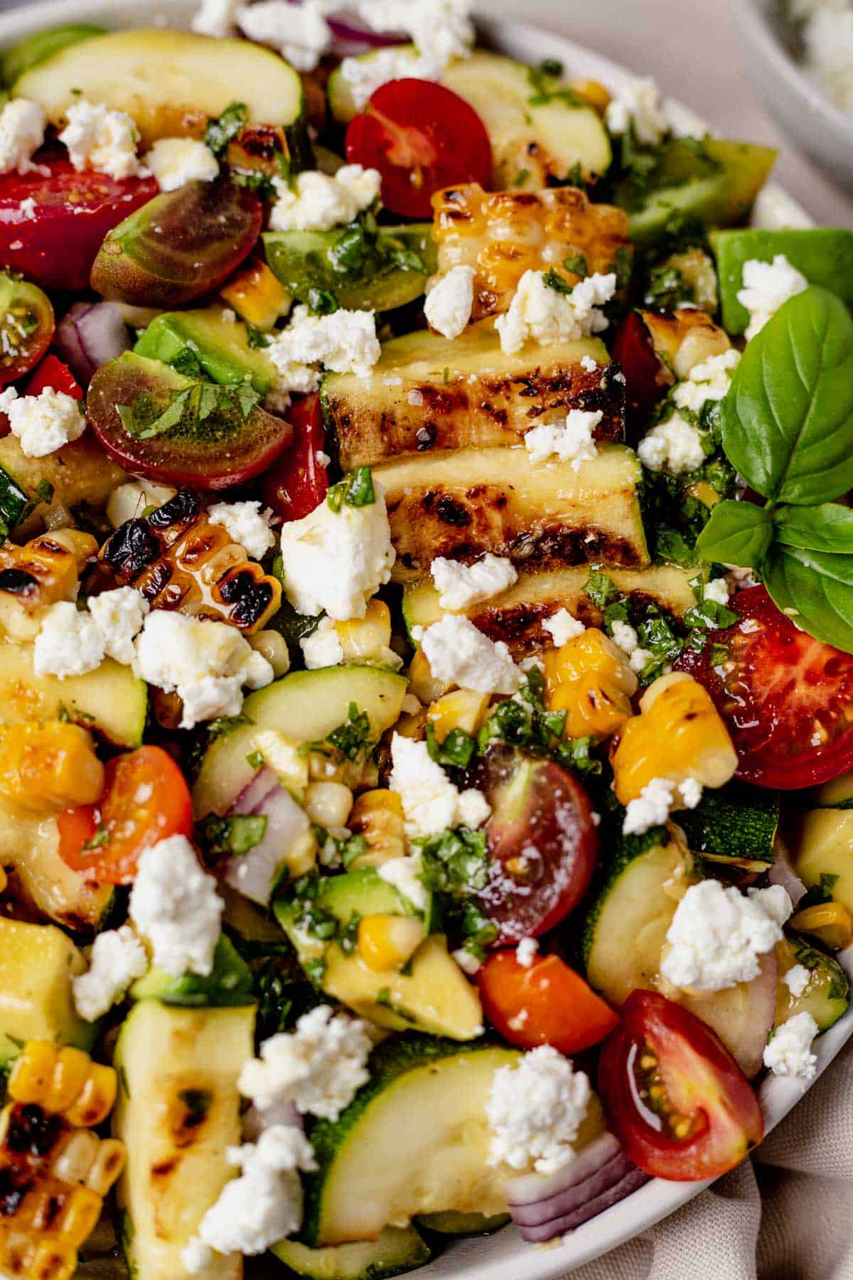 grilled zucchini salad topped with fresh basil