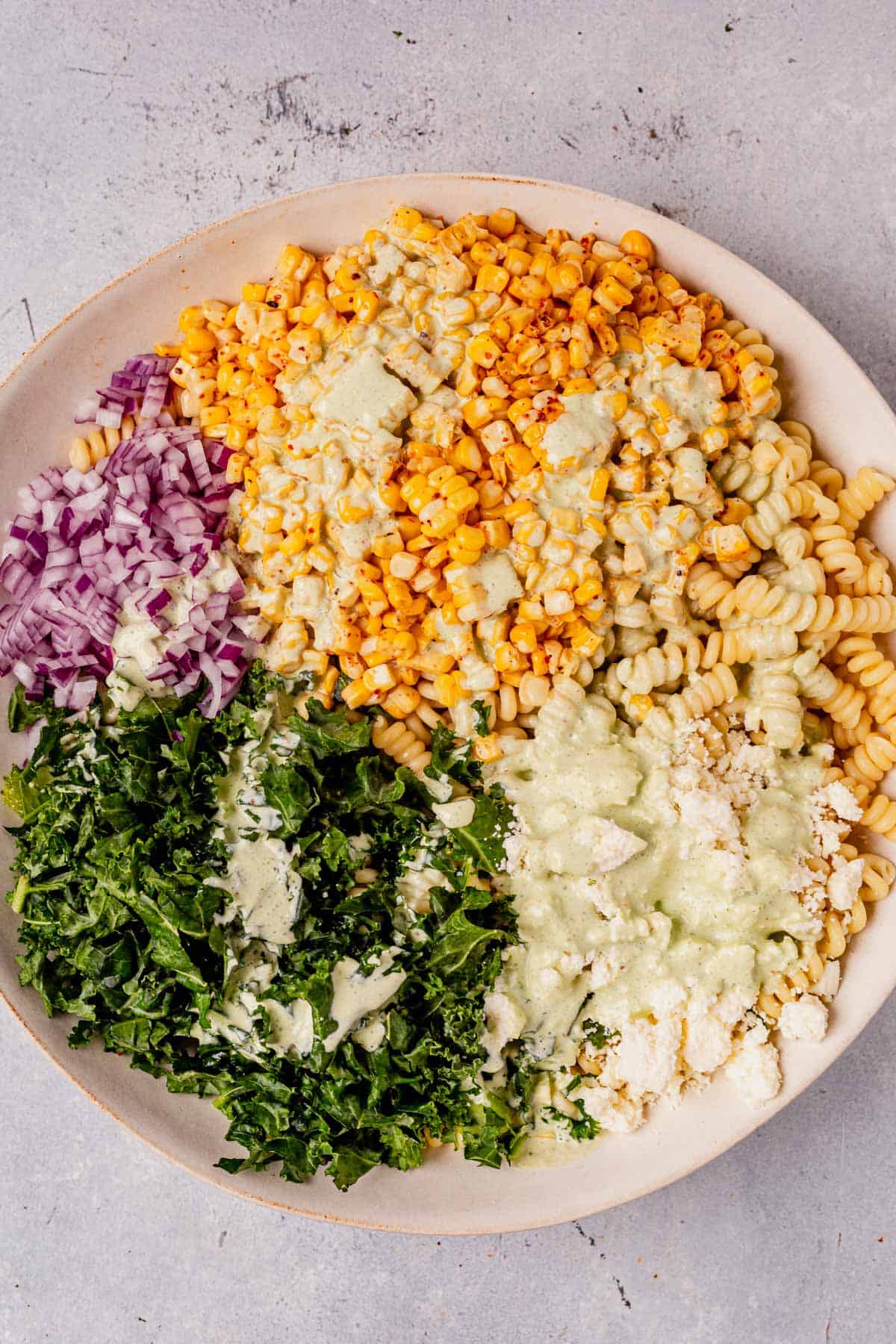 mexican street corn pasta salad ingredients in a serving bowl