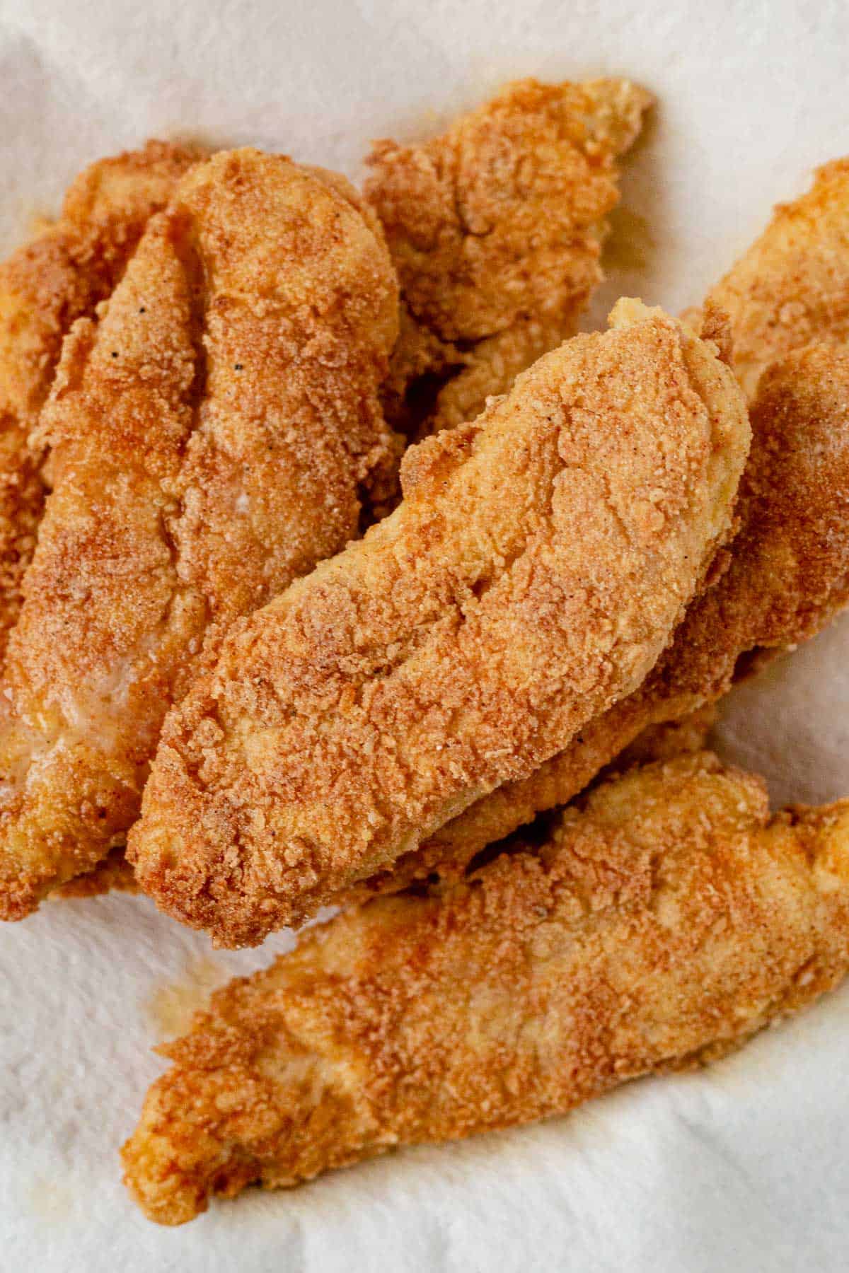 crispy fried chicken strips on a paper towel