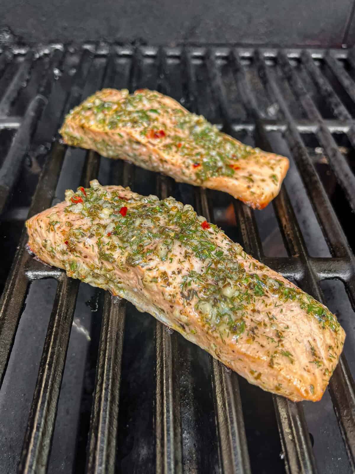 greek salmon cooking on the grill