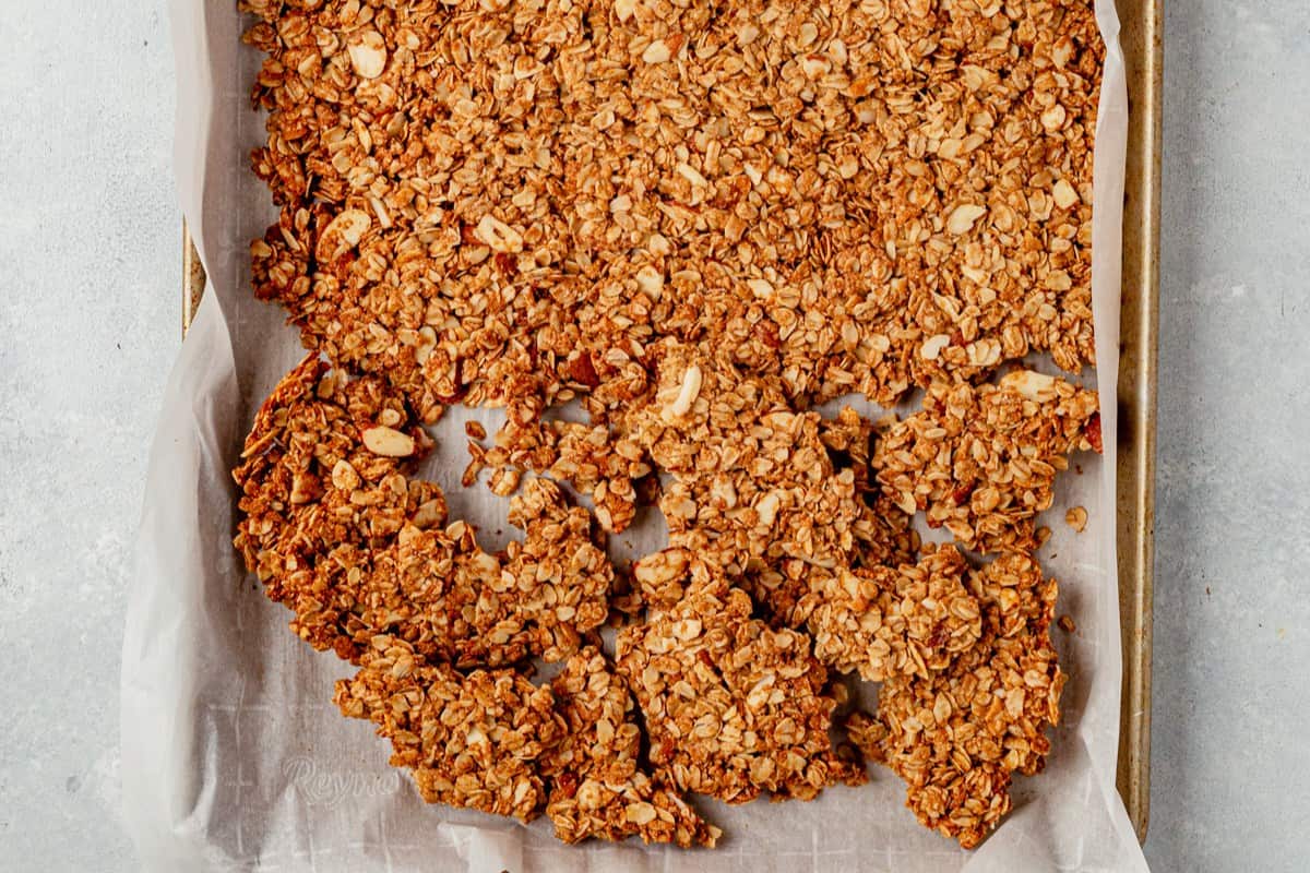 large chunks of vanilla almond granola broken on a sheet pan