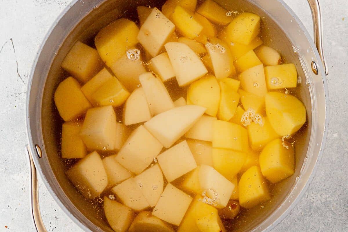 peeled and diced yukon and russet potatoes in a pot of water