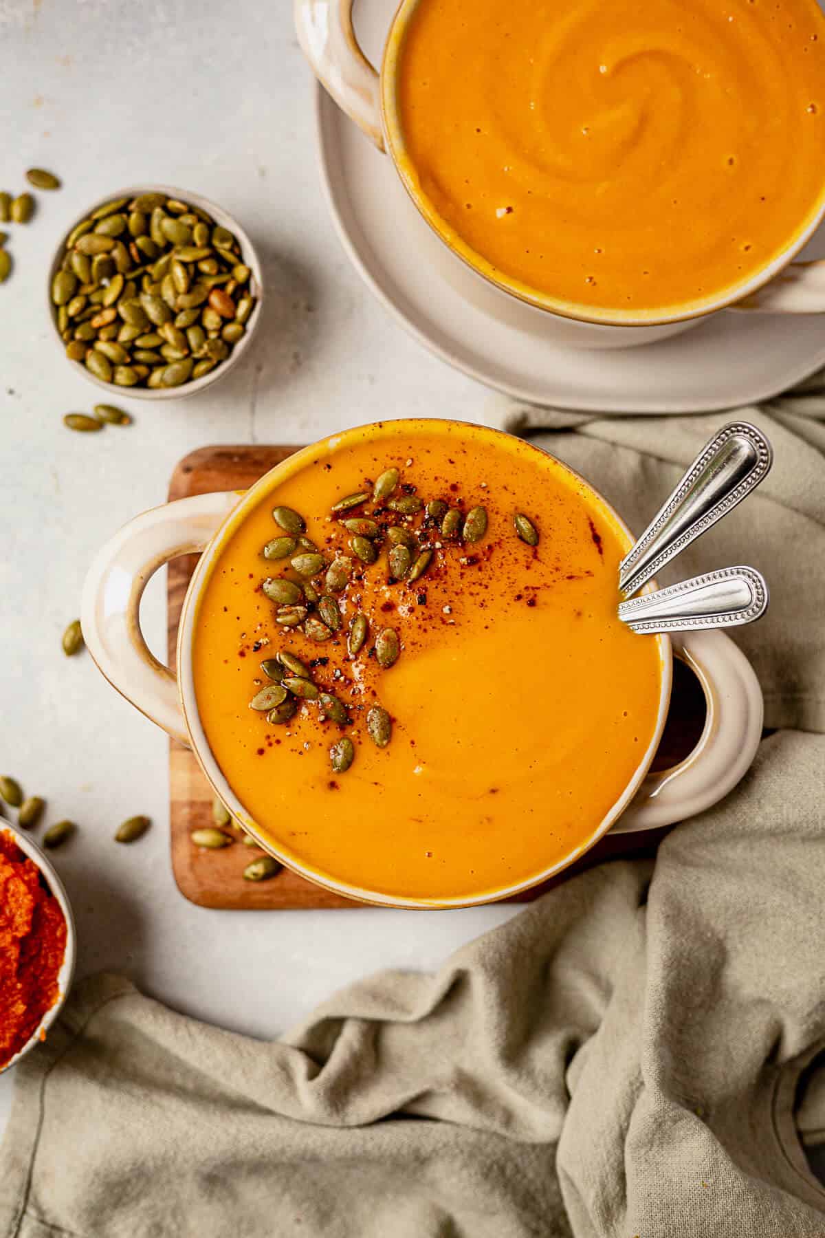 two spoons in a bowl of panera autumn squash soup