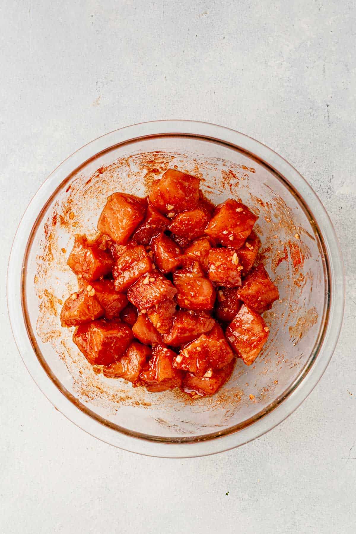 marinated salmon bites in a glass bowl