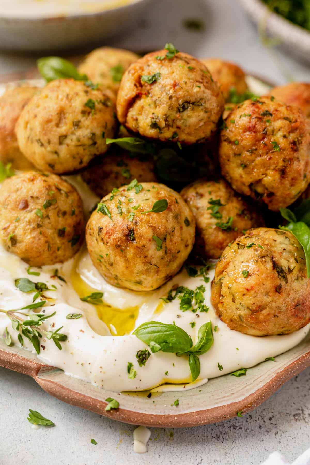 greek chicken meatballs on top of whipped feta