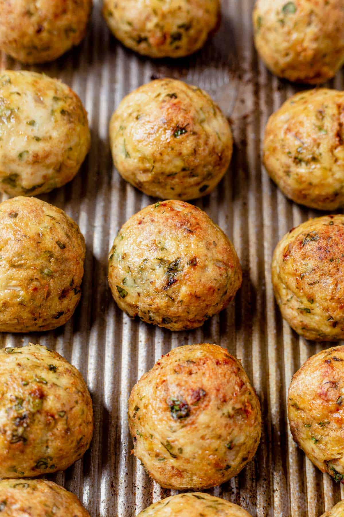 greek chicken meatballs baked on a sheet pan