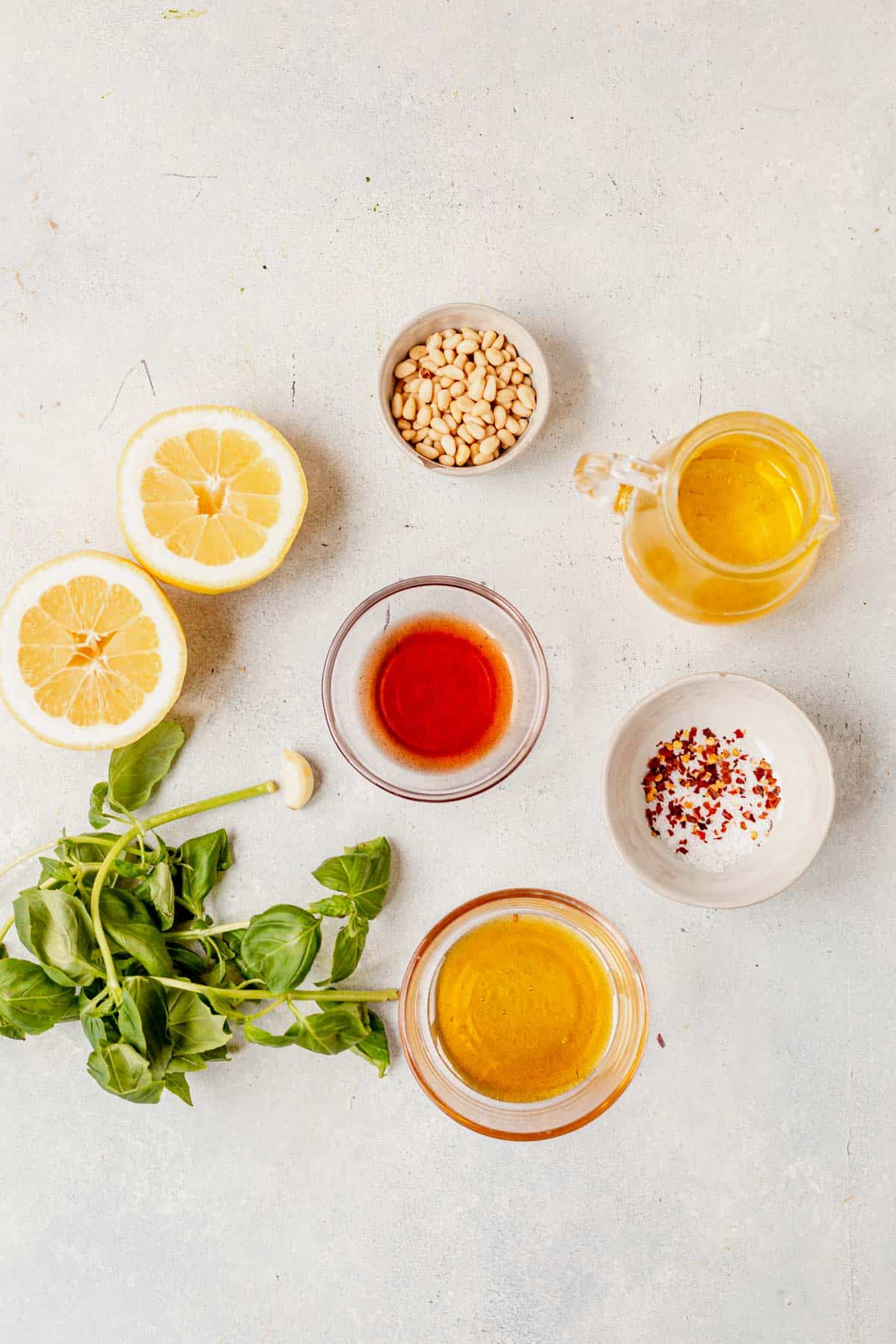 ingredients for lemon orzo pasta salad ressing in bowls on a counter