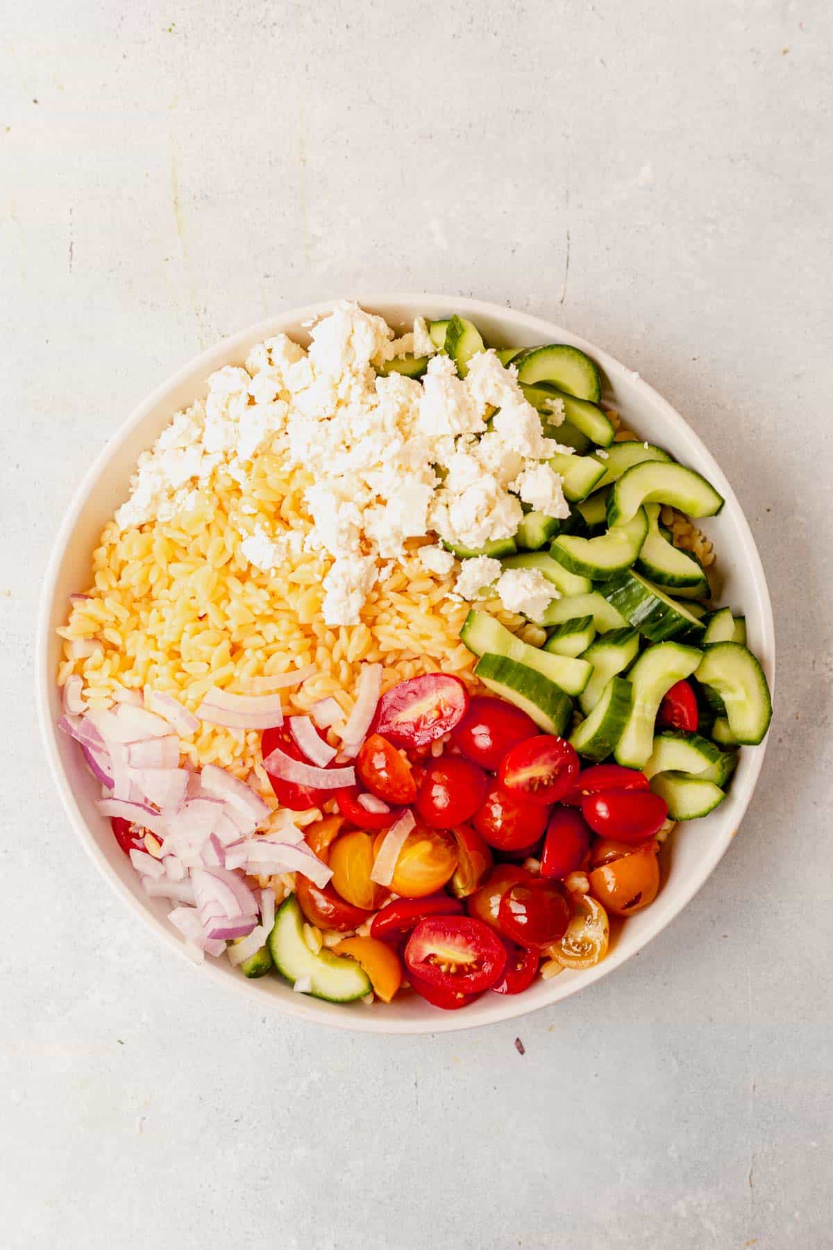 ingredients for lemon orzo pasta in a large bowl