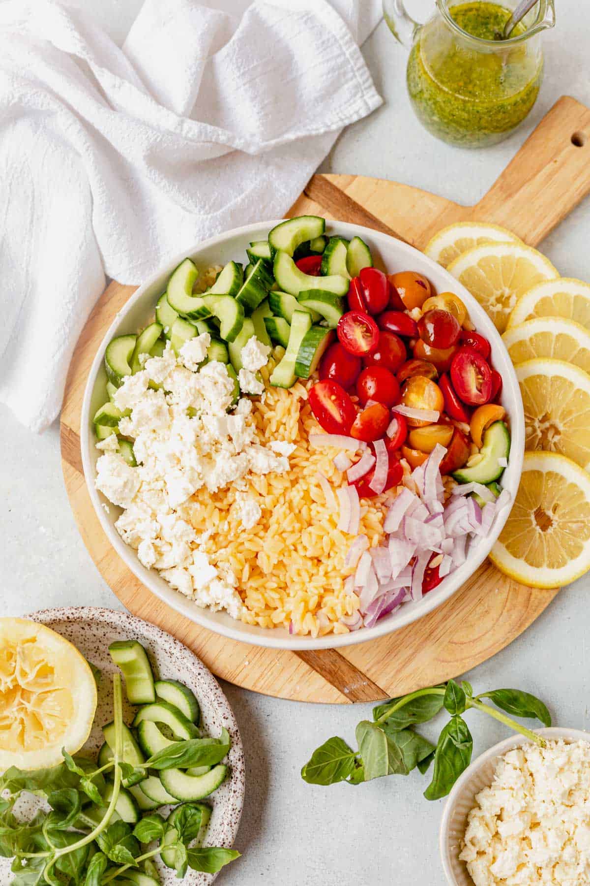 ingredients for lemon orzo pasta salad  in a bowl before being combined