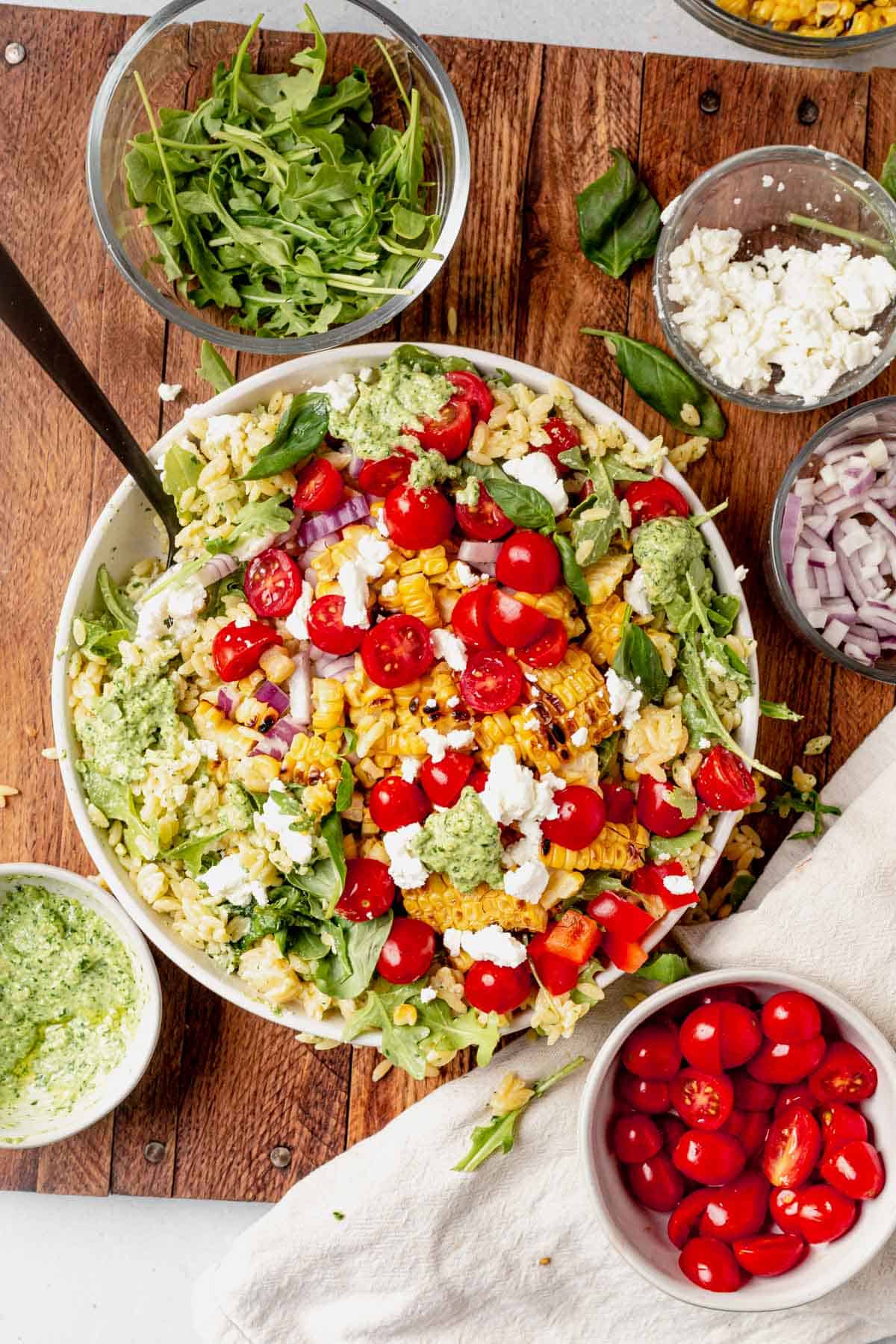 summer orzo pasta salad ingredients in a bowl