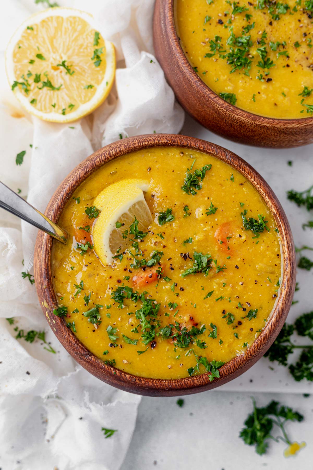 two bowls of lemon lentil soup on the table