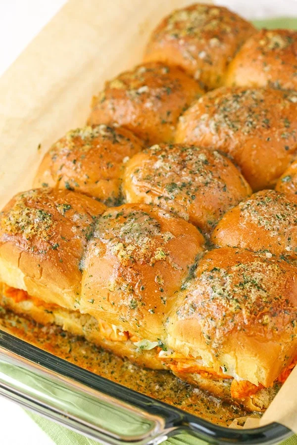 buffalo chicken sliders in a glass baking dish