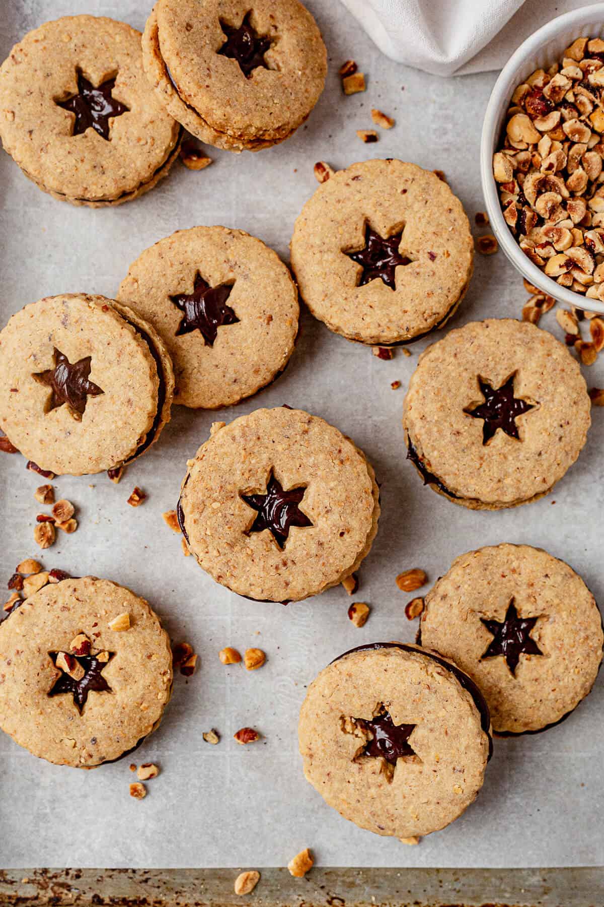 freshly baked hazelnut shortbread sandwiches with chocolate ganache on a cookie sheet