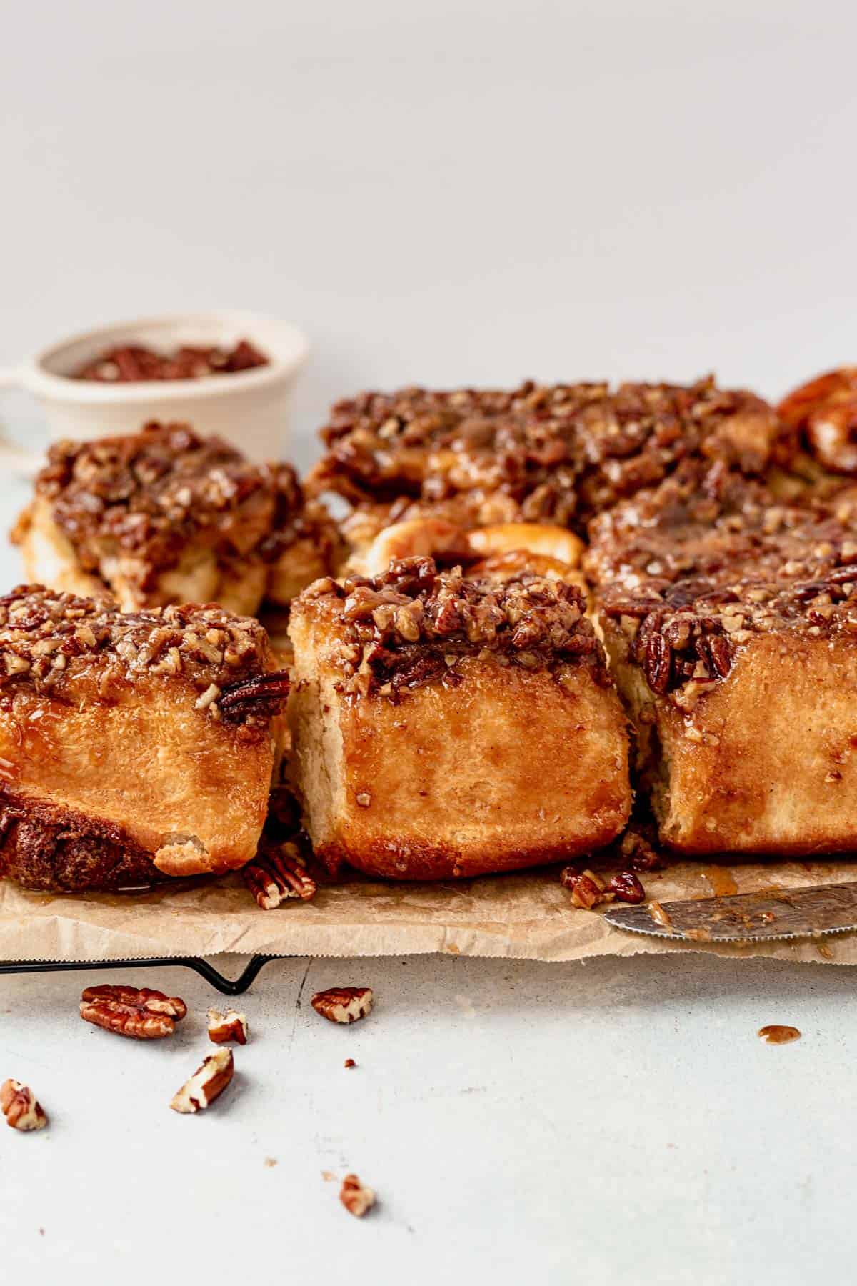 sticky buns pulled apart cooling on parchment paper