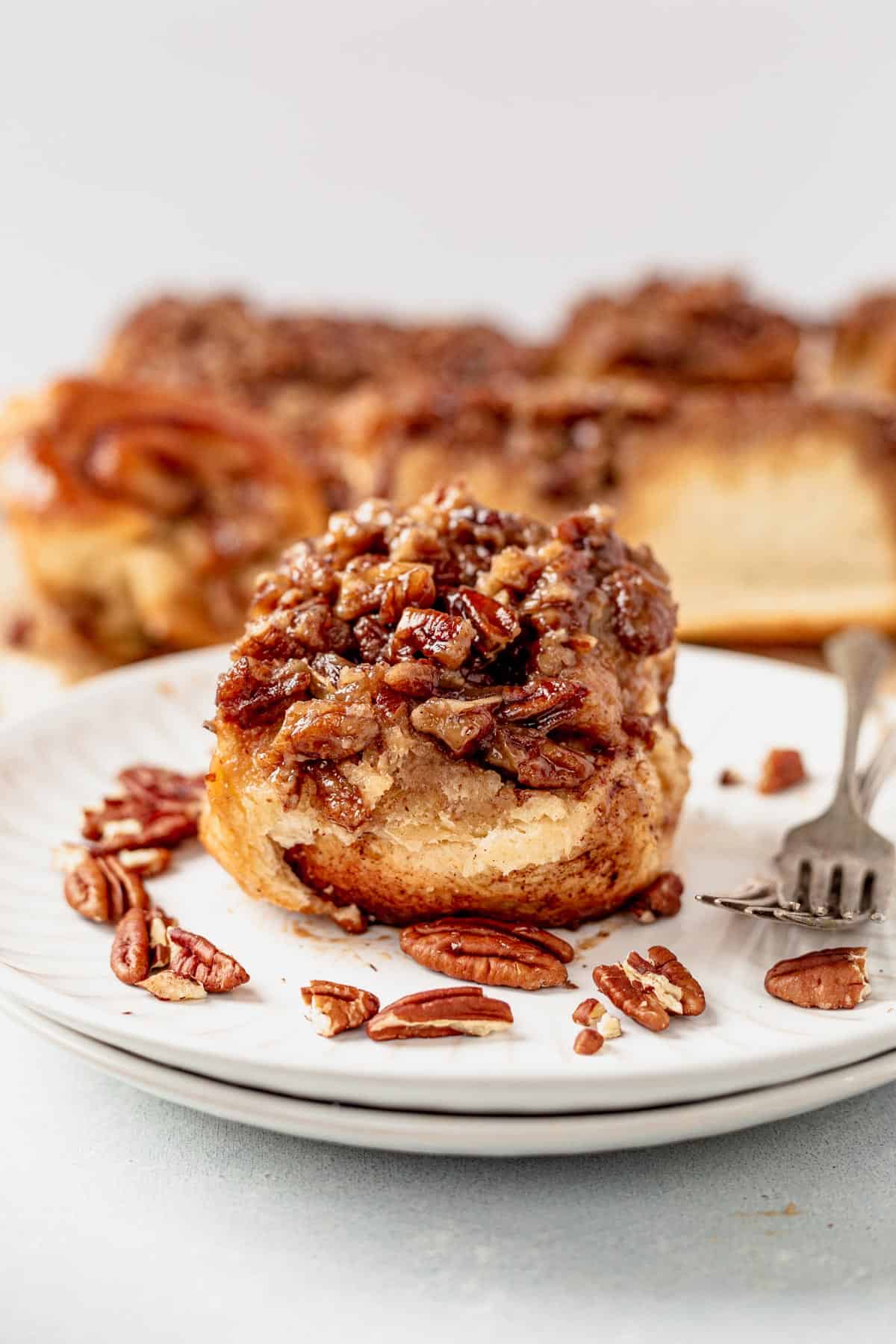 sticky bun on a plate with a fork