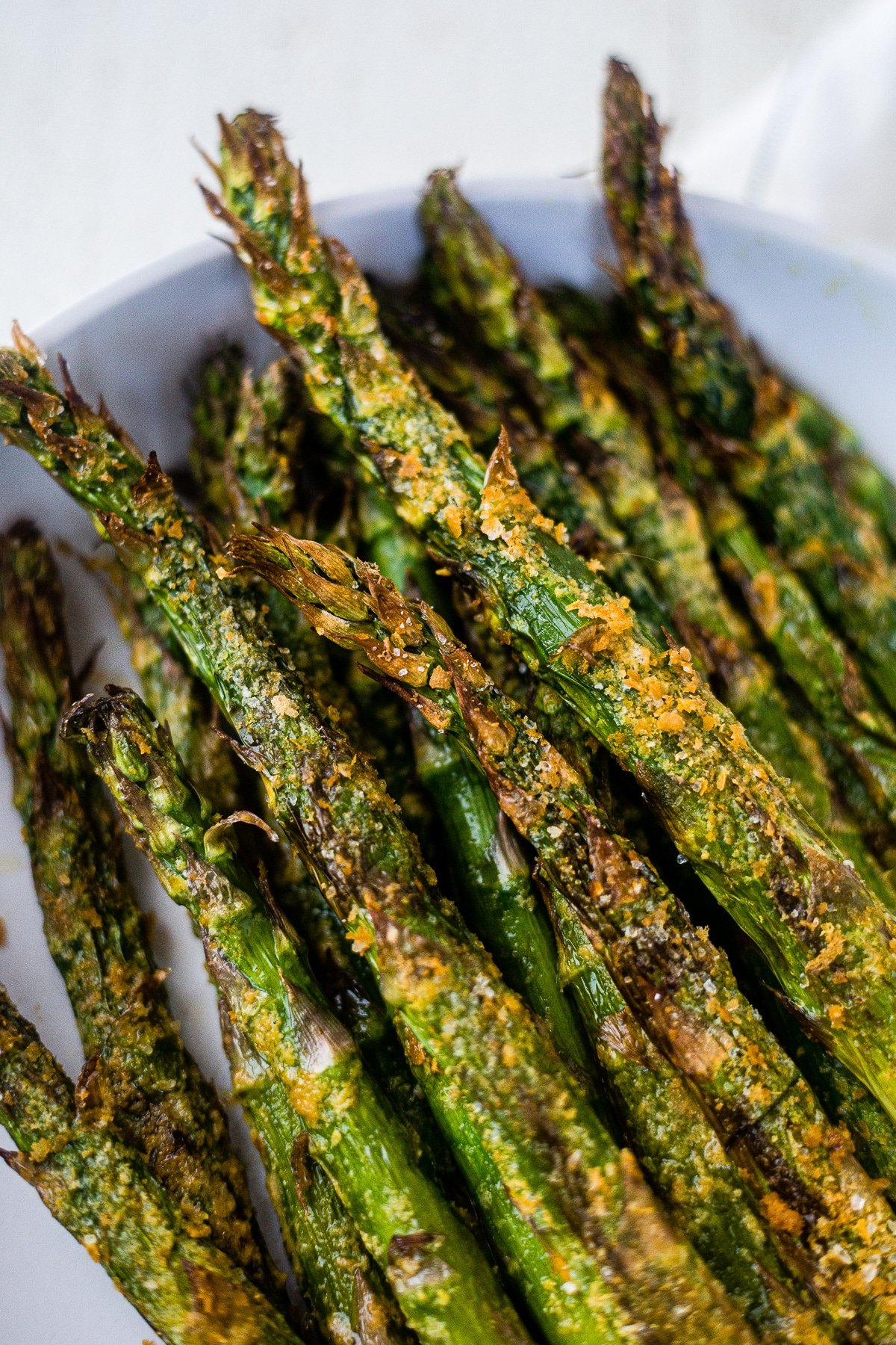 close up of air fryer asparagus coated in avocado oil, salt and nutritional yeast