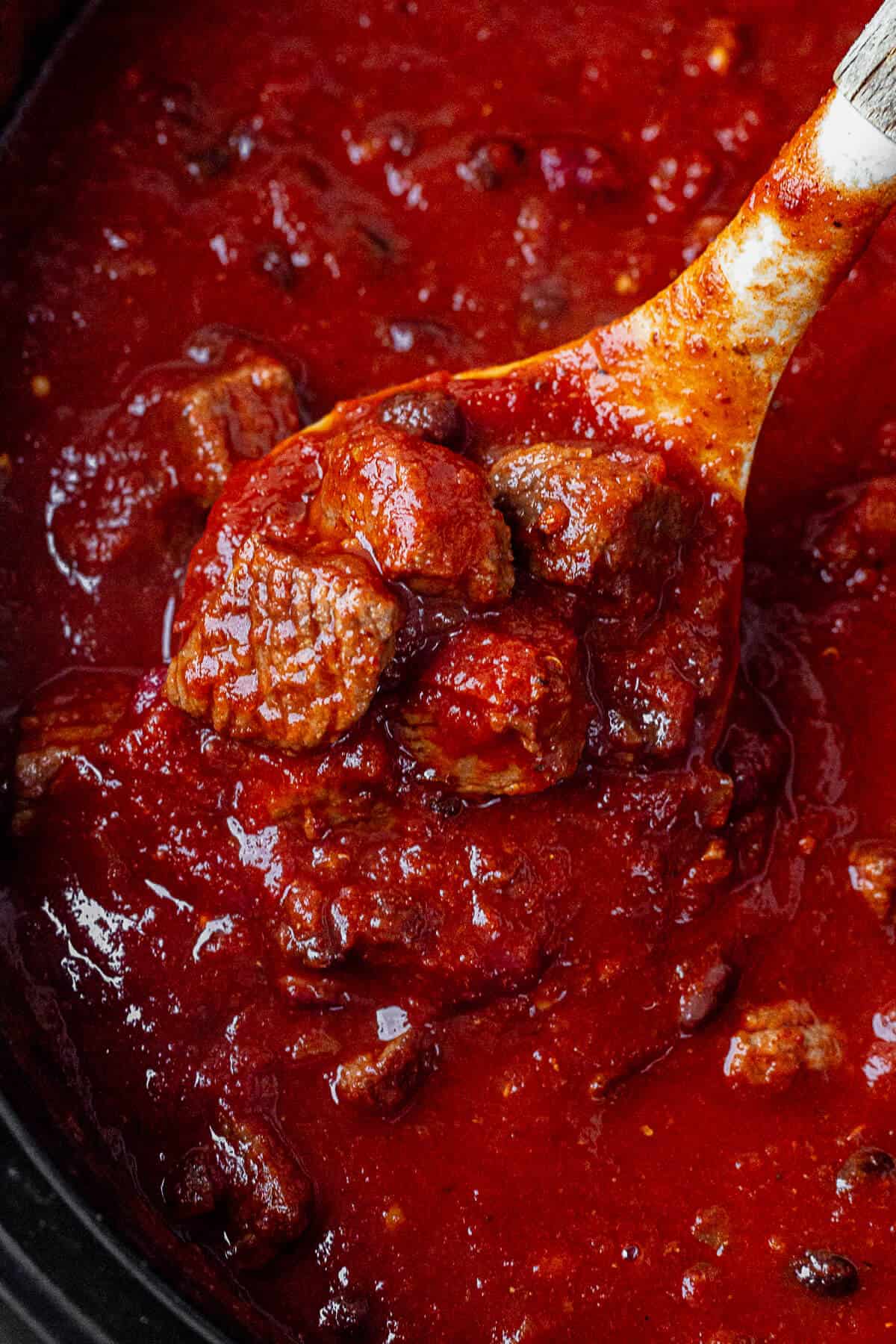 ladling steak chili out of the crock pot