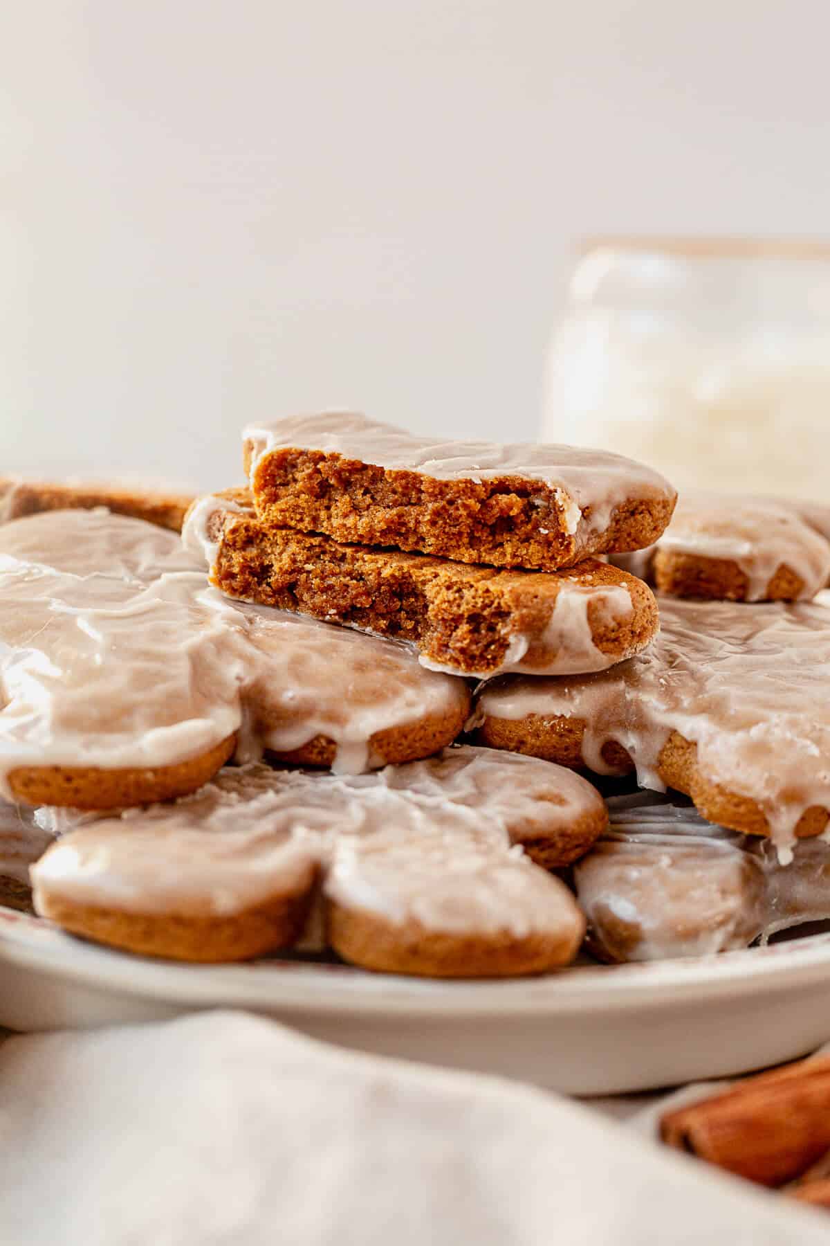 a soft gingerbread cookie broken in half on top of more cookies