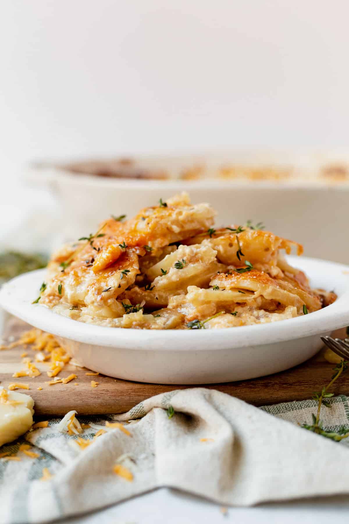 cheesy scalloped potatoes in a white dish