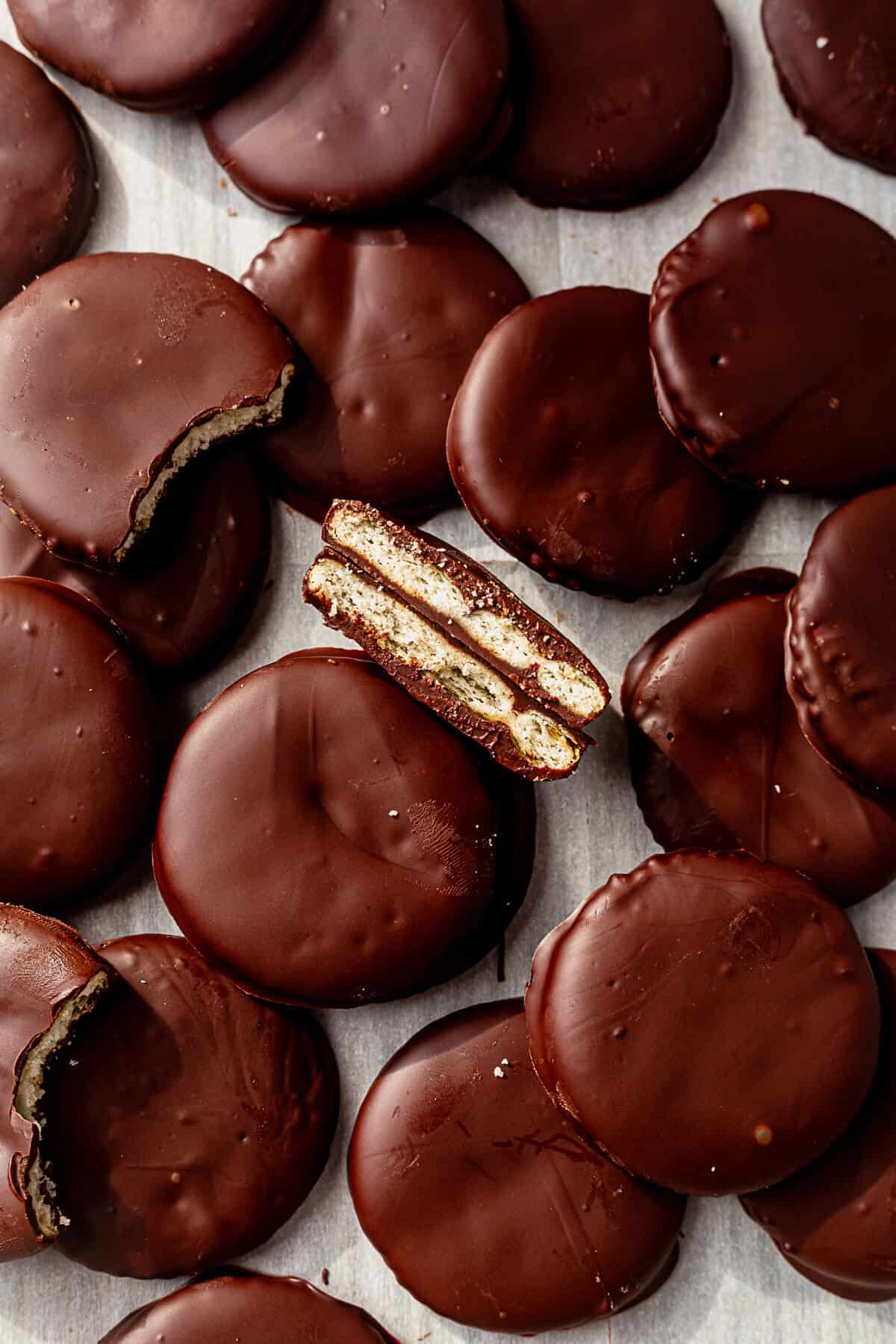 ritz thin mints on a piece of parchment paper and one cut in half