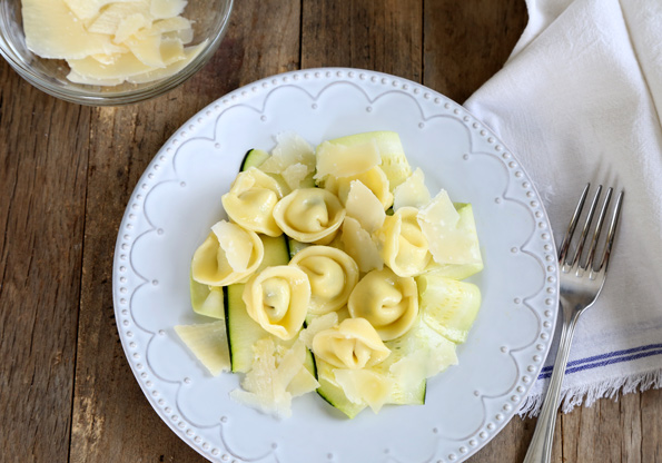 Overhead view of tortellini on a white plate 