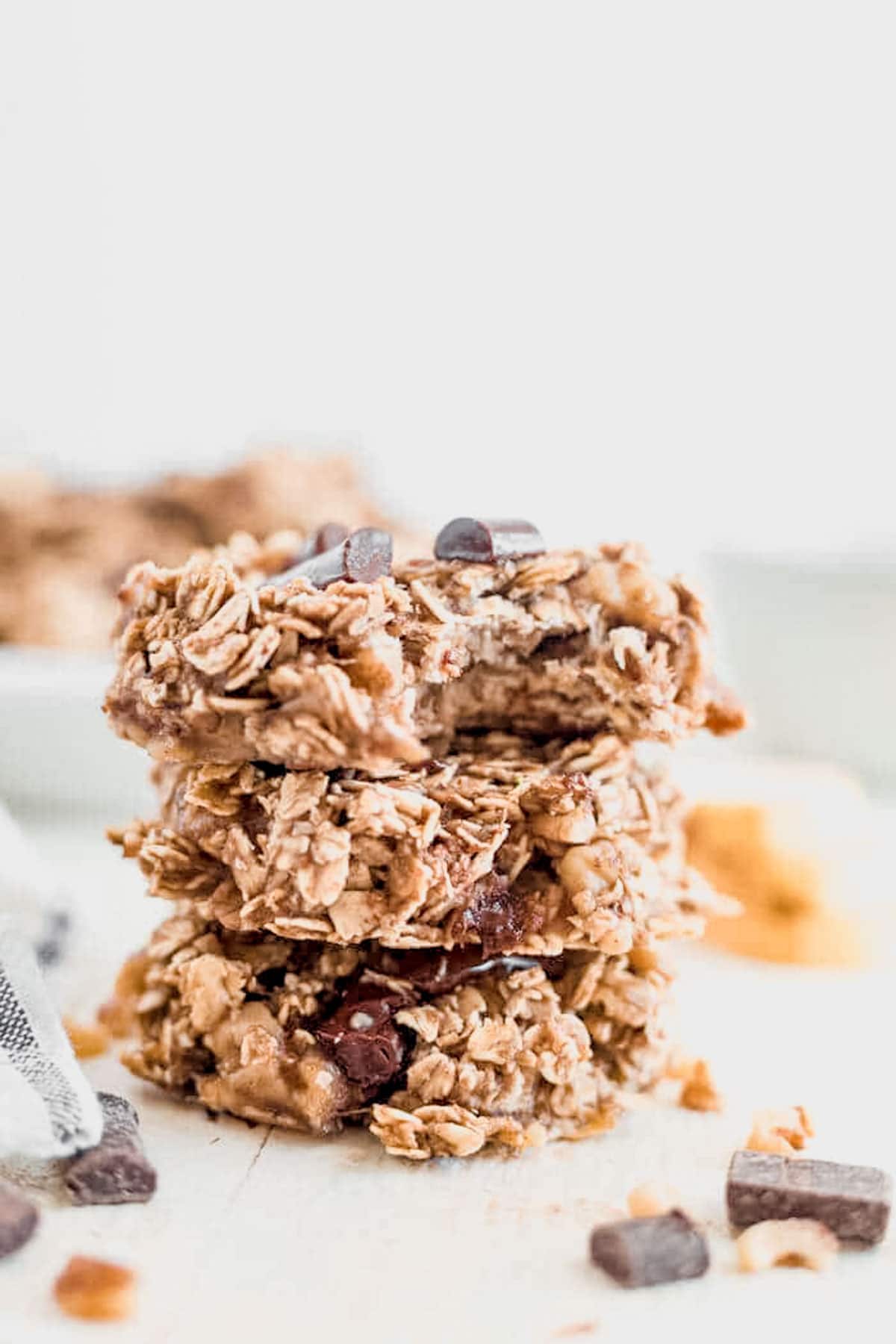 three banana oatmeal cookies stacked on a countertop