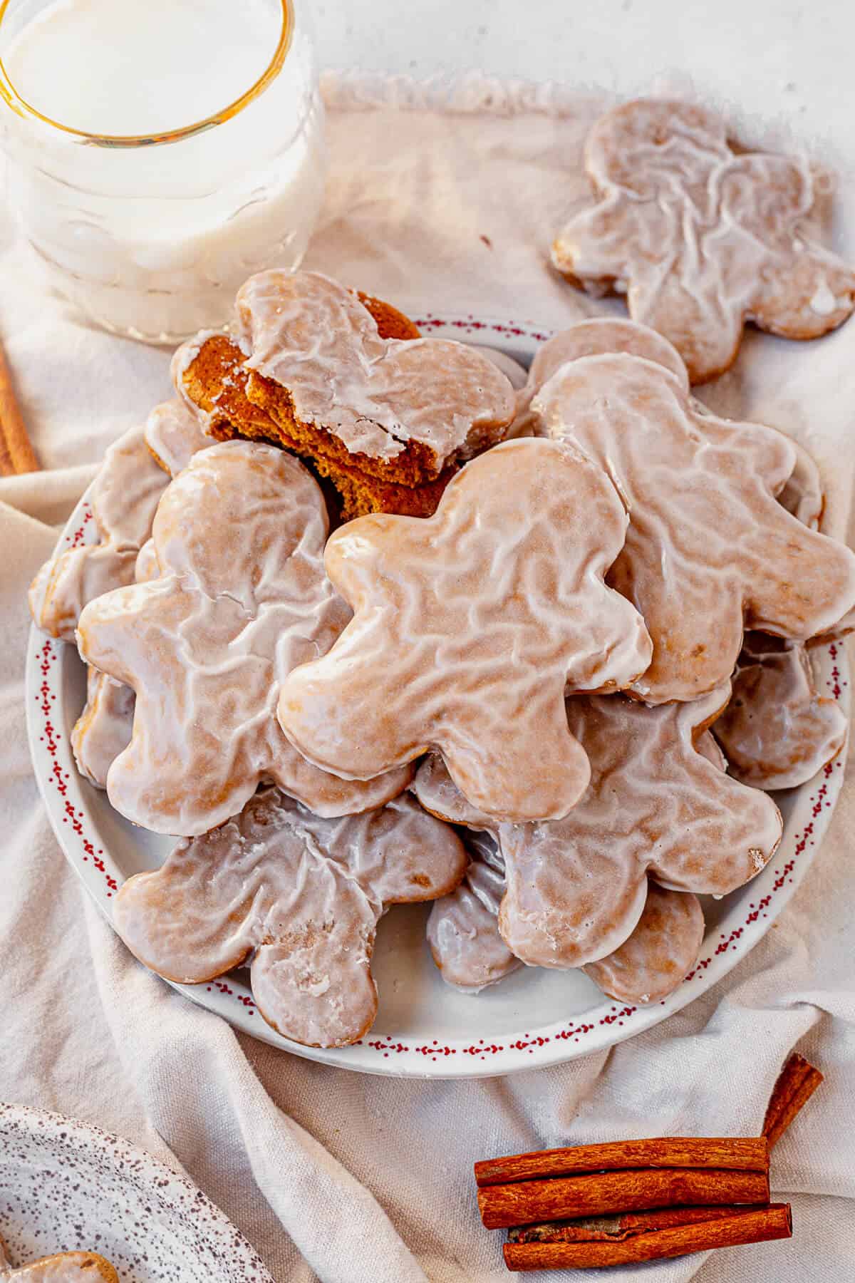 a plate of soft gingerbread cookies with a glass of milk