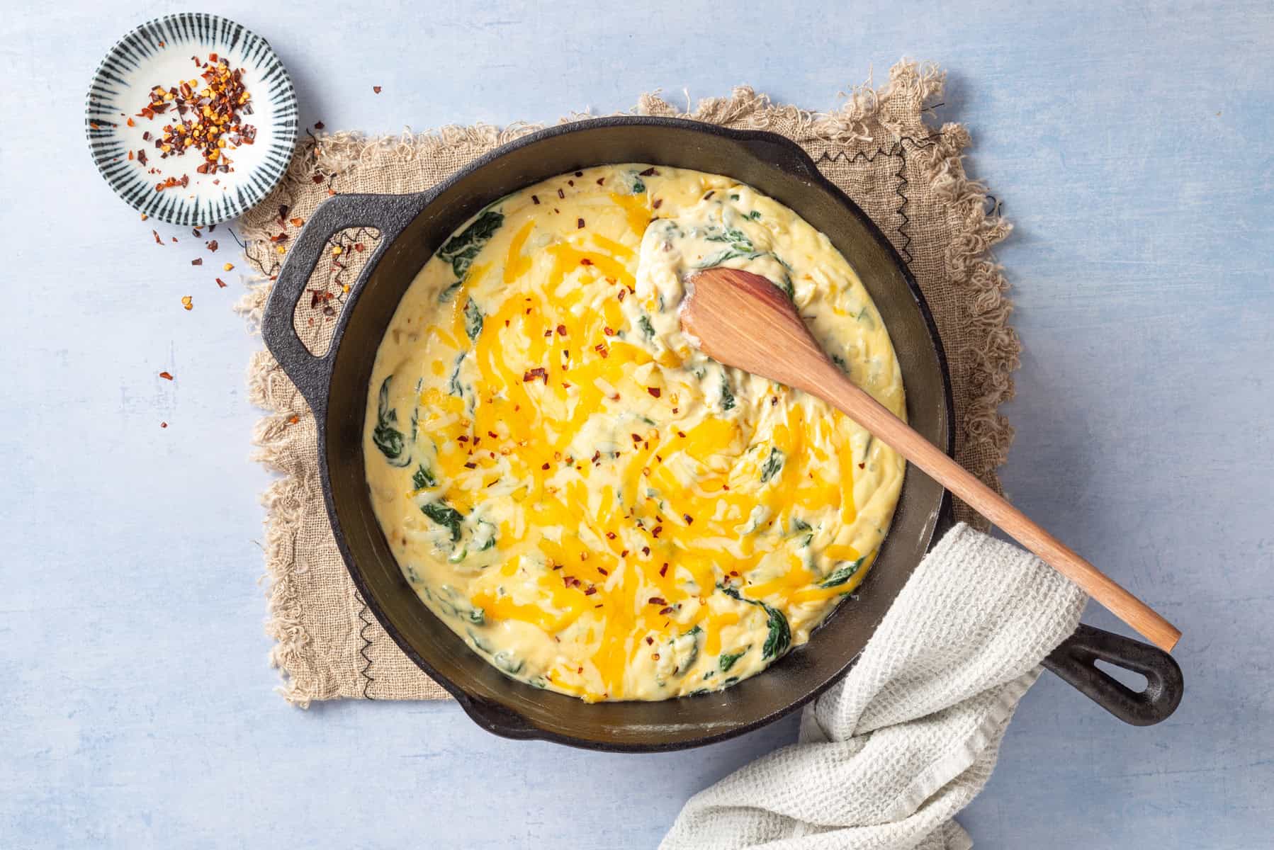 An image of creamed spinach in a skillet.