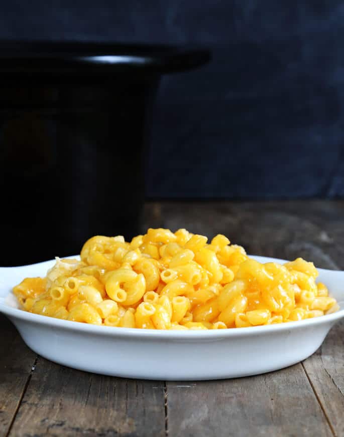 A simple custard-style gluten free macaroni and cheese that's made ridiculously easy in the slow cooker. It's even easier than the boxed kind, since you don't even have to boil the pasta! 