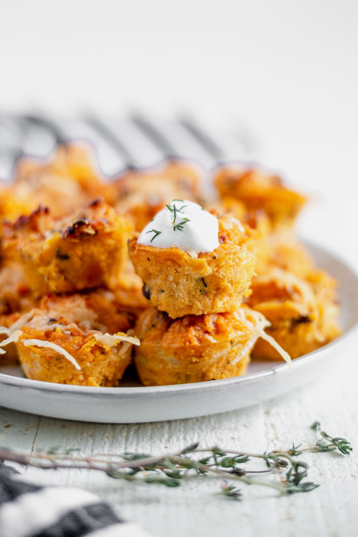 sweet potato puffs stacked on a white plate for serving