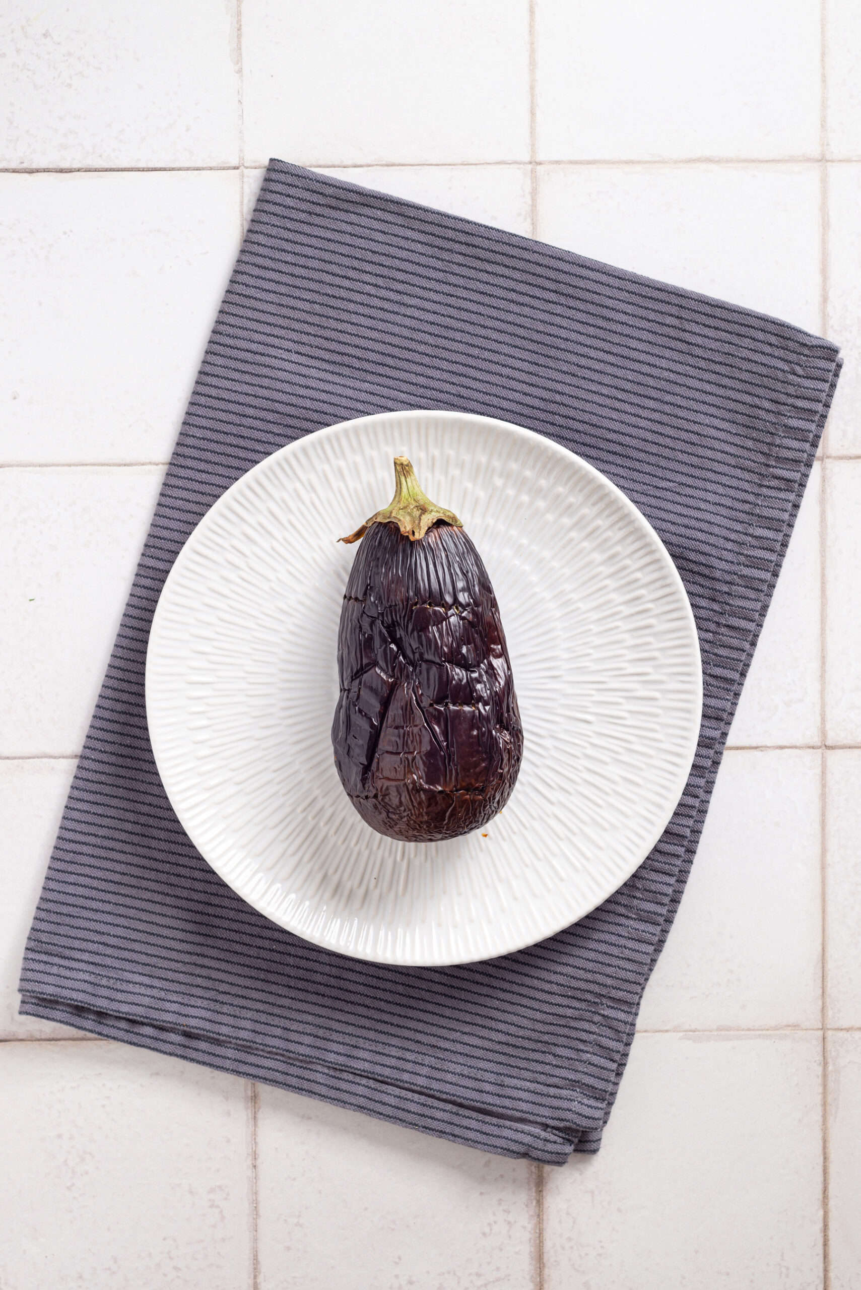 An overhead image of a roasted eggplant.