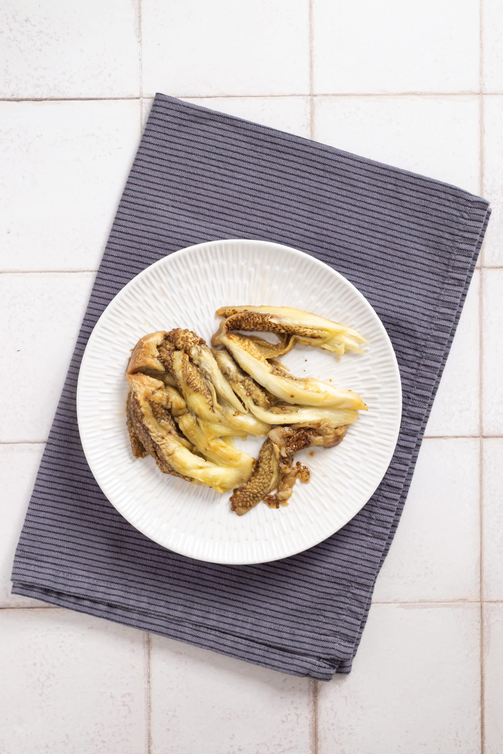 An image of roasted eggplant flesh on a plate.