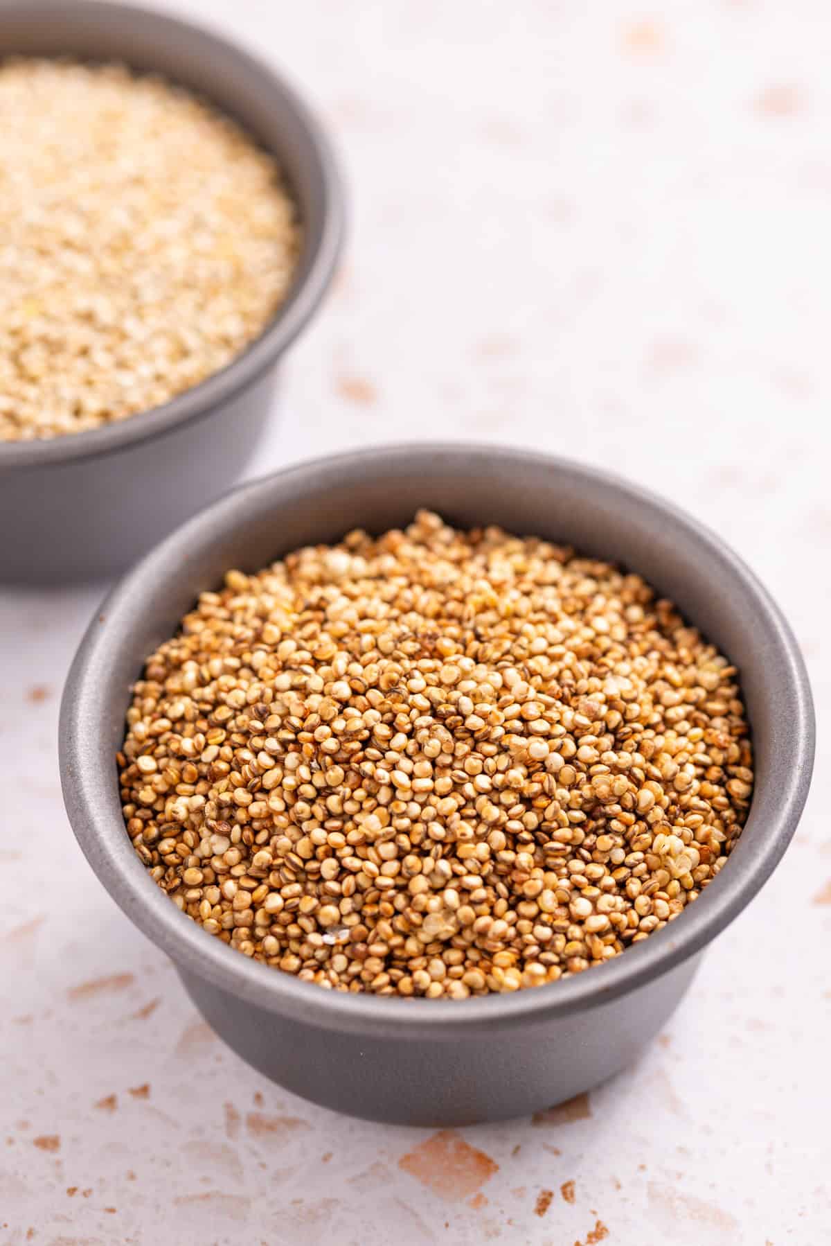 An straight view image of puffed quinoa in a container.