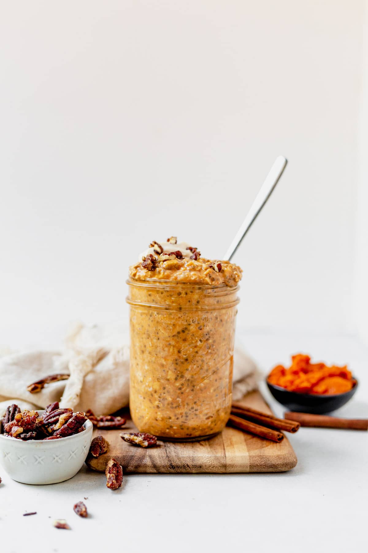 pumpkin overnight oats in a jar with a spoon