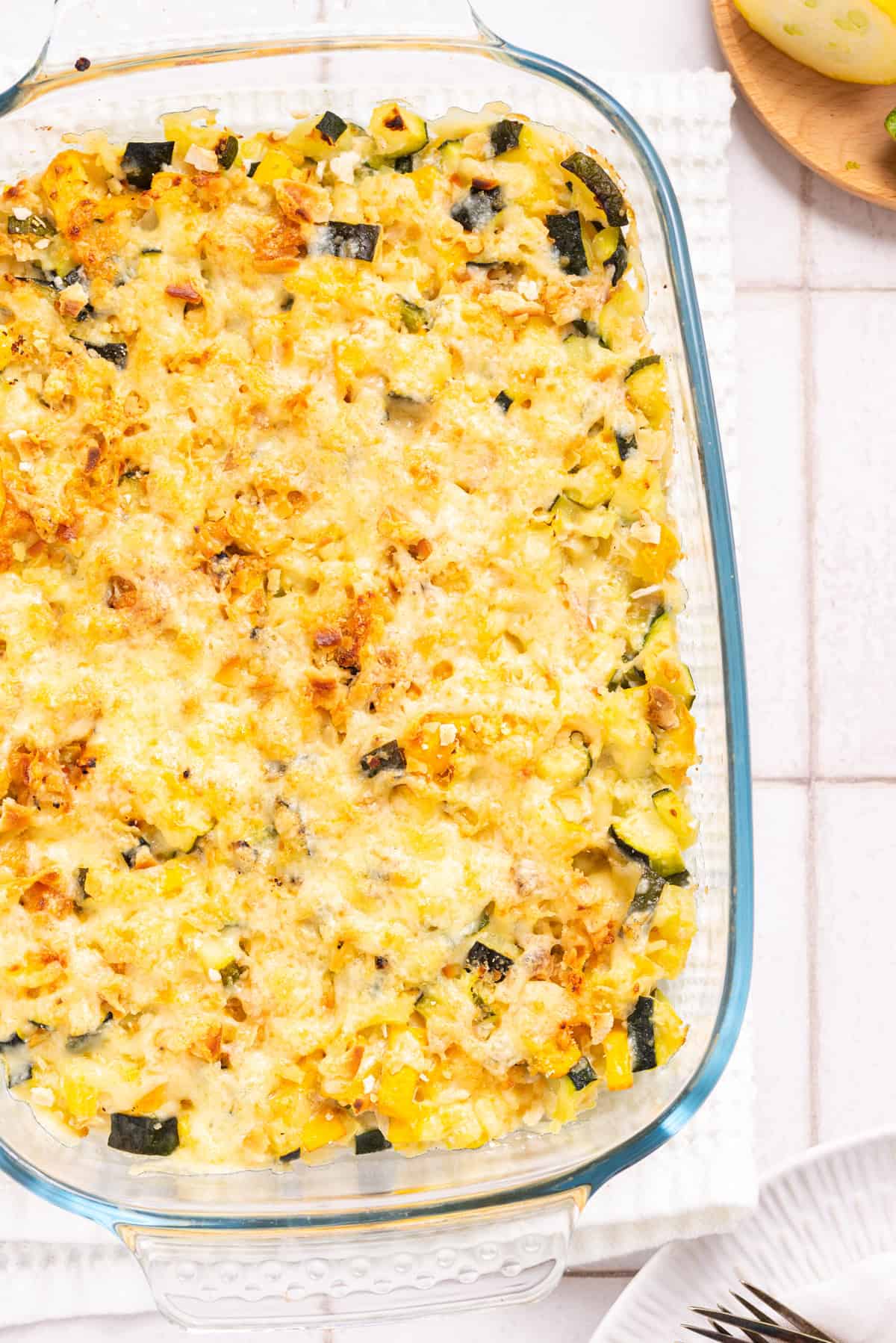 An overhead image of squash and zucchini casserole in a clear baking dish.