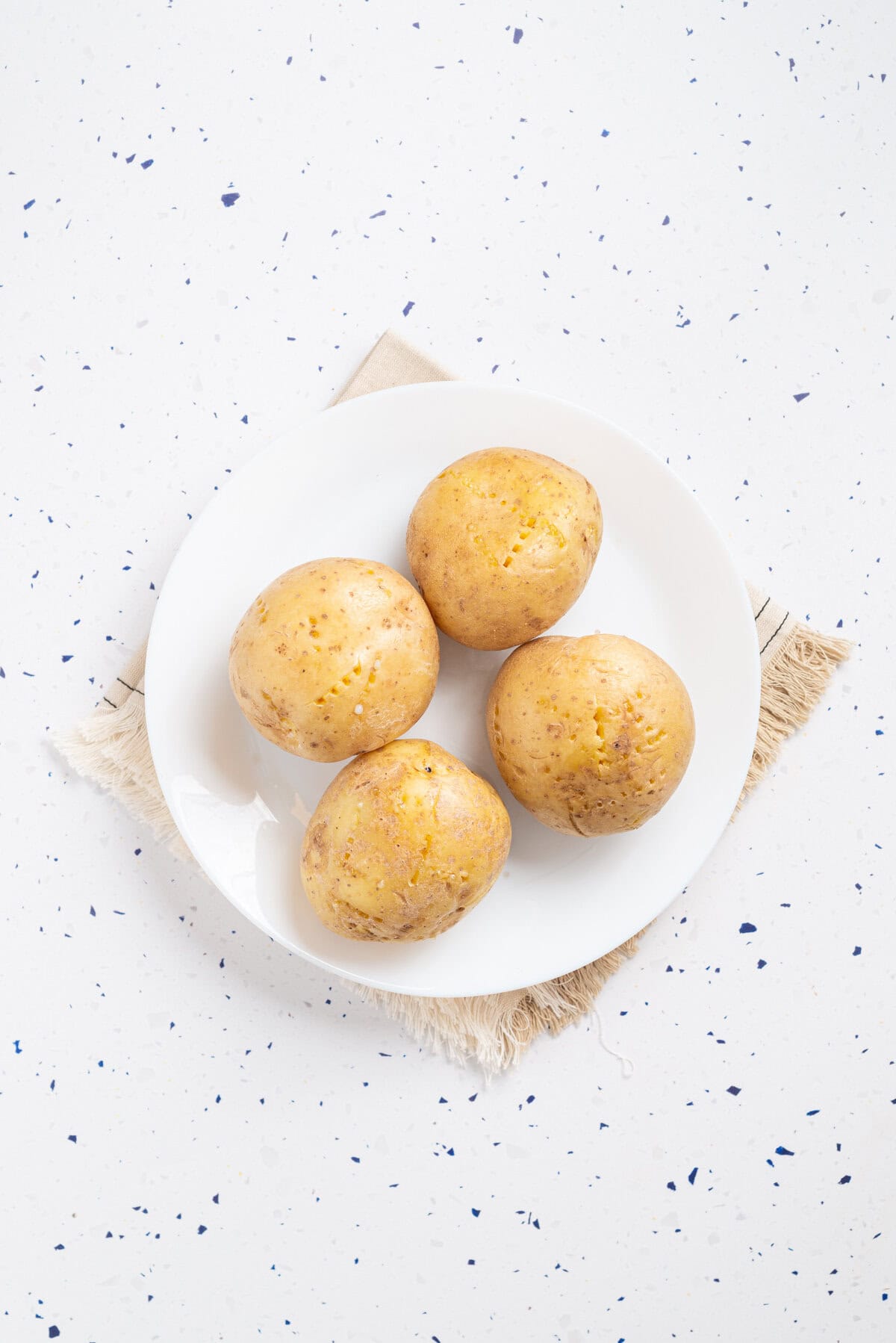 An image of pierced potatoes on a plate.