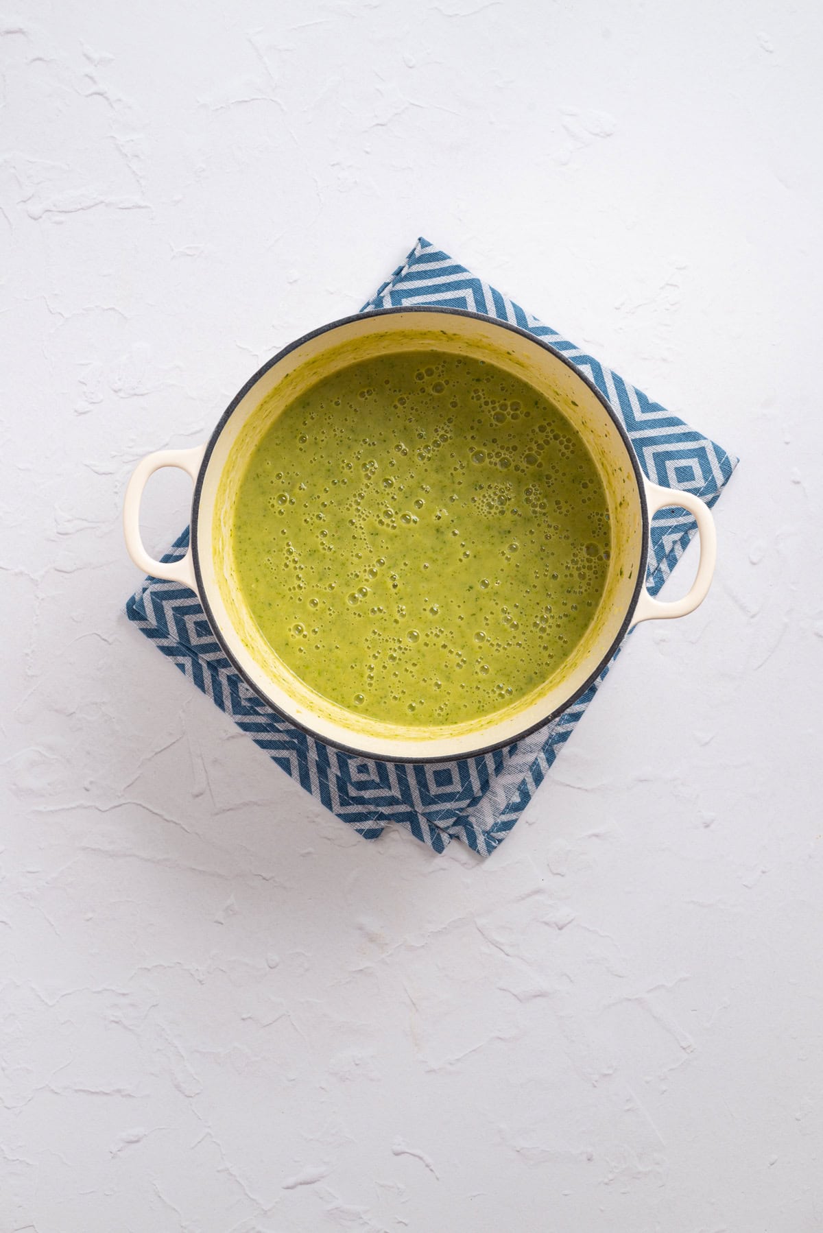 An overhead image of zucchini soup mixture blended until smooth.